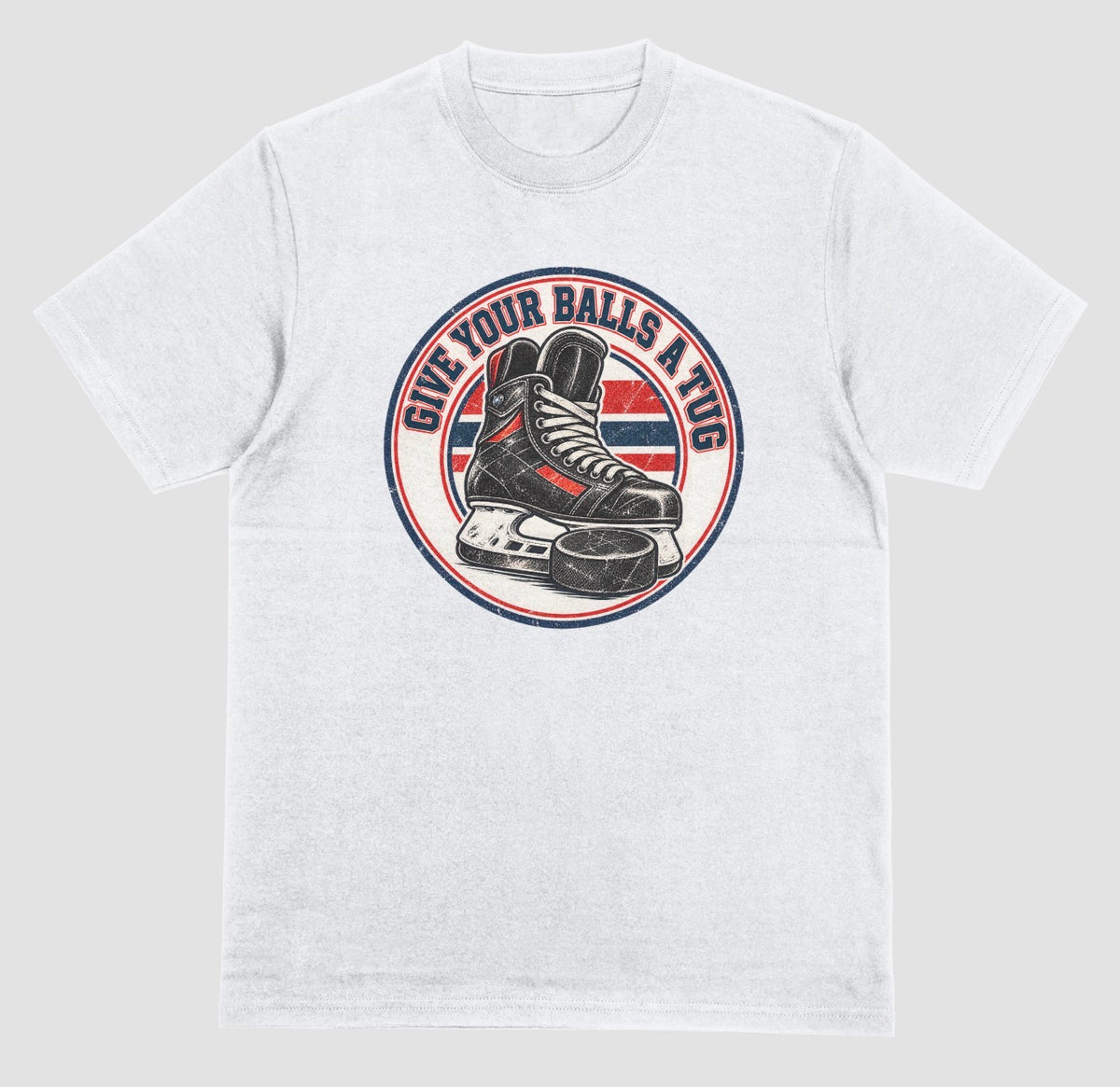 A white t-shirt with a round vintage crest reading 'Give Your Balls a Tug' around a hockey skate and puck in red, white, and blue.