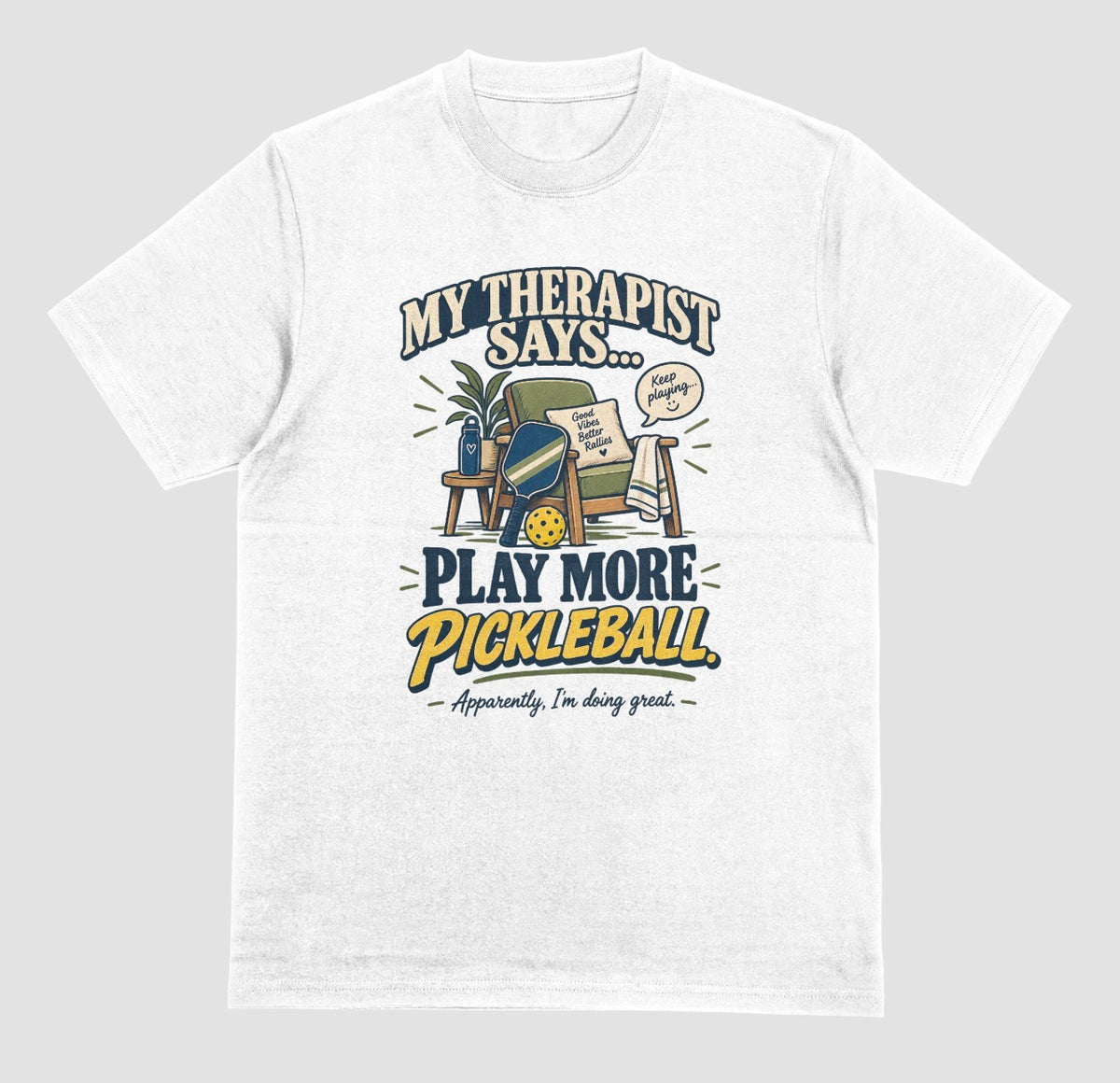 A white Funny pickleball shirt with an armchair and paddle design that says My Therapist Says Play More Pickleball
