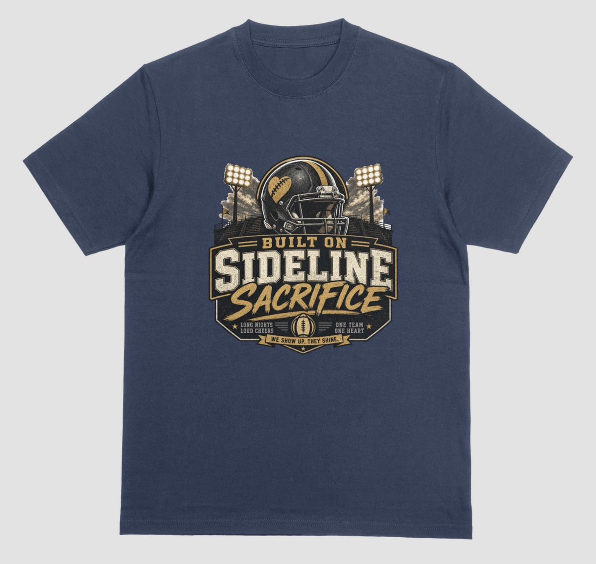 A navy blue crewneck t-shirt featuring a football-themed graphic on the chest with the text 'BUILT ON SIDELINE SACRIFICE' and a helmet illustration, shown against a light gray background.