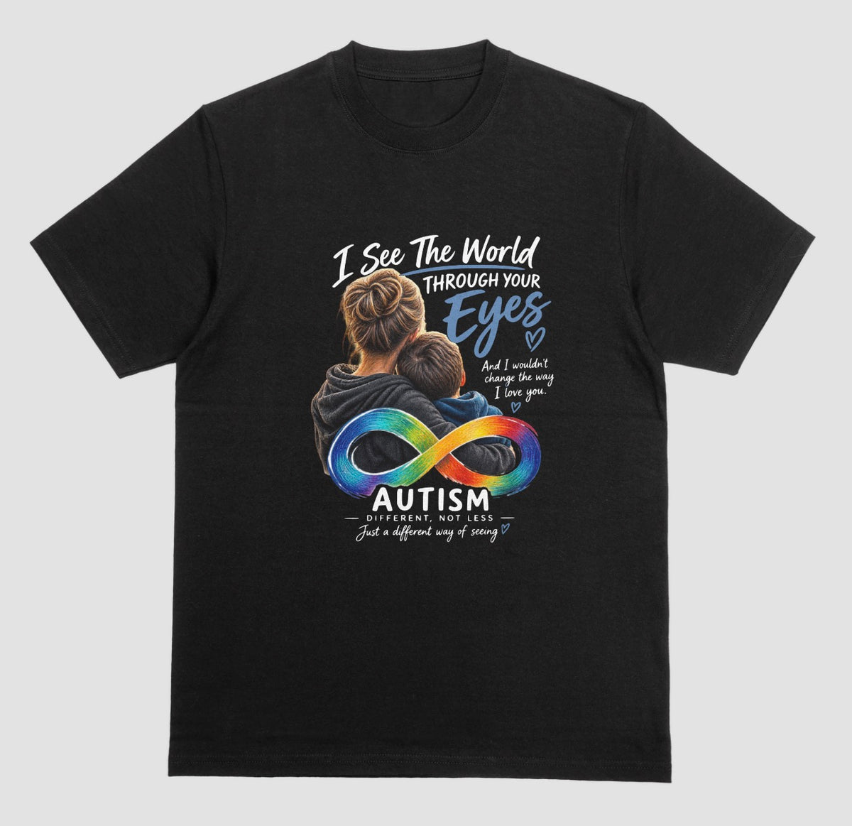 A black t-shirt with a graphic of a parent hugging a child, a rainbow infinity symbol, and the text ‘I See the World Through Your Eyes’ and ‘Autism: Different, Not Less.’