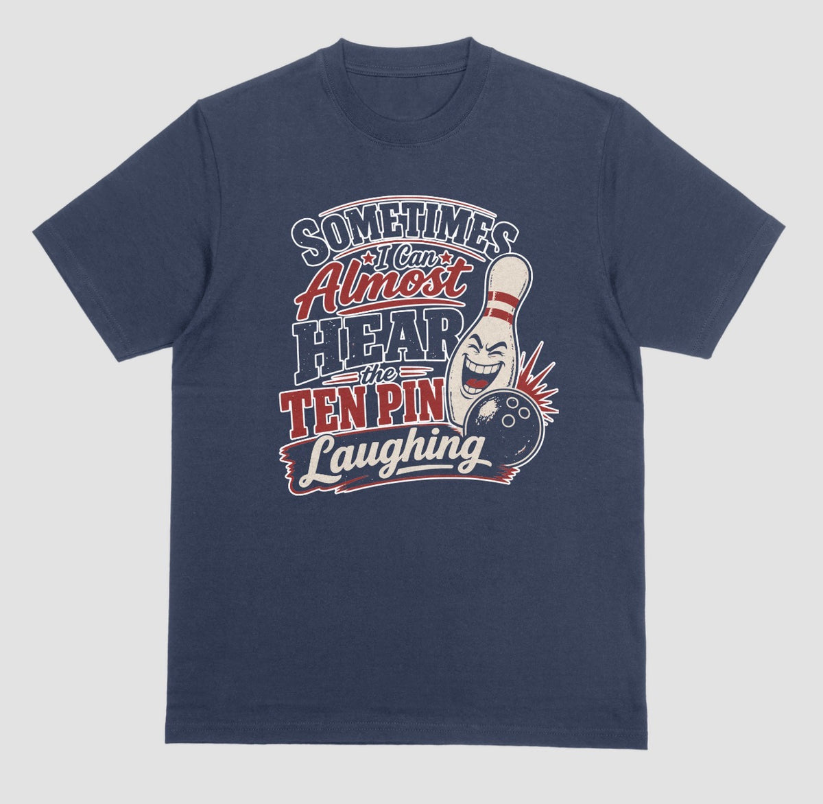 A navy blue t-shirt with the funny bowling quote "Sometimes I Can Almost Hear the Ten Pin Laughing" in red, black, and cream lettering beside a laughing bowling pin and black bowling ball
