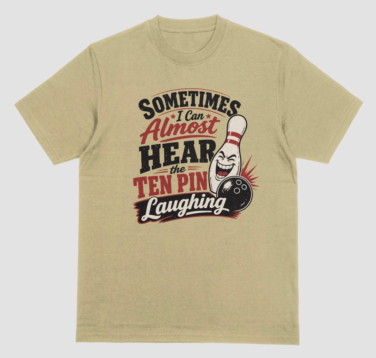 A sand color t-shirt with the funny bowling quote "Sometimes I Can Almost Hear the Ten Pin Laughing" in red, black, and cream lettering beside a laughing bowling pin and black bowling ball
