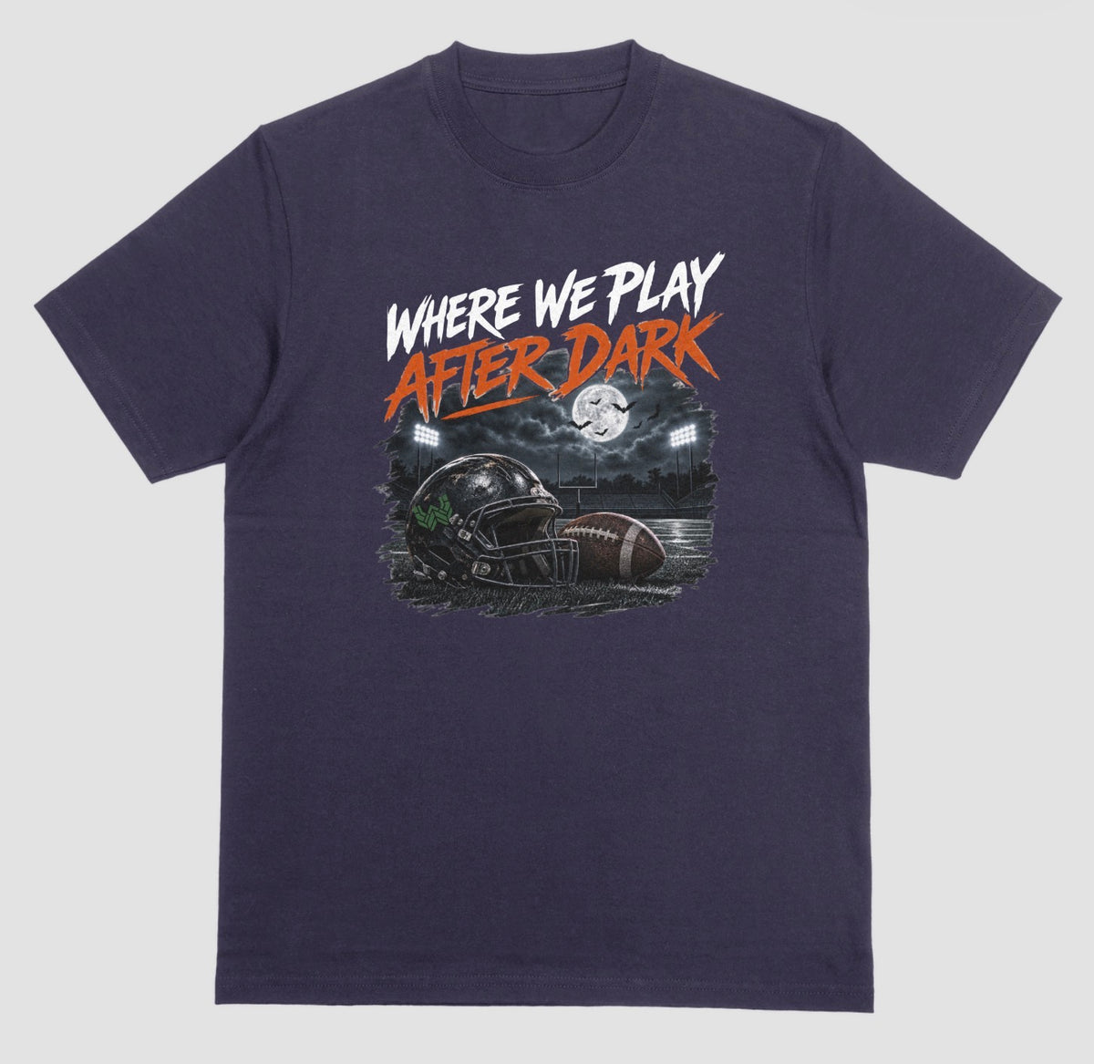 A blackberry short-sleeve graphic t-shirt featuring the text 'WHERE WE PLAY AFTER DARK' in white and orange lettering above a football-themed illustration, displayed on a neutral light gray background.