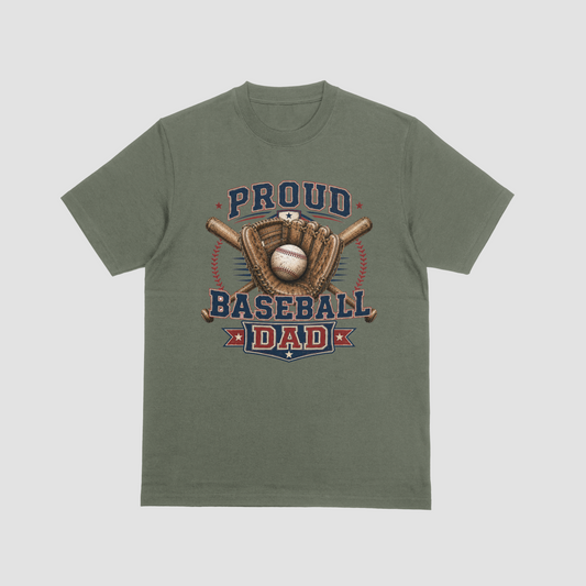 A military green short sleeve crewneck Baseball Dad t-shirt featuring a baseball-themed graphic with the words “PROUD BASEBALL DAD,” along with baseball and baseball equipment details.