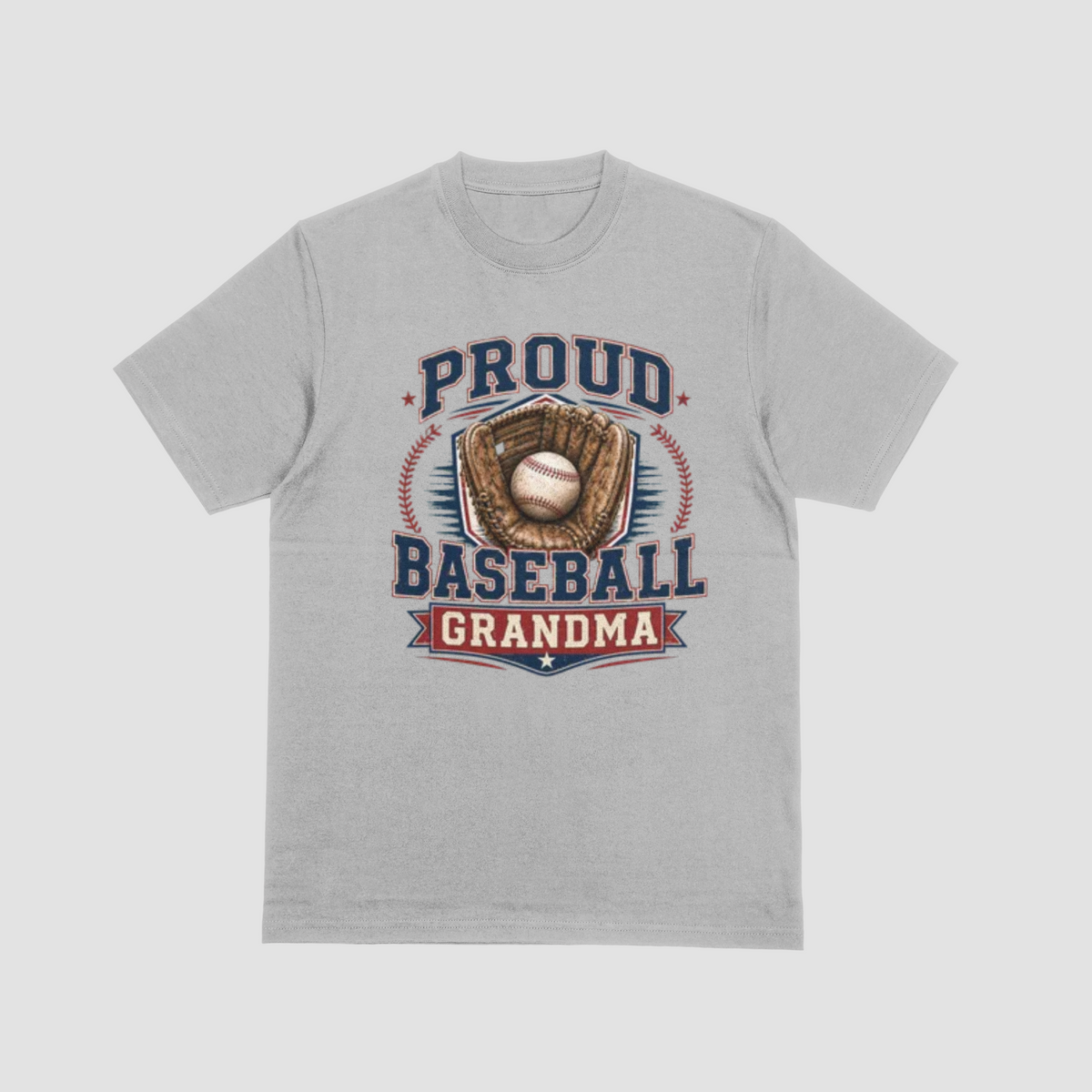 A light gray short-sleeve crewneck t-shirt with a vintage-style baseball graphic on the front. The graphic features the text 'PROUD BASEBALL GRANDMA' in navy blue and red, surrounding an illustration of a baseball in a brown glove.