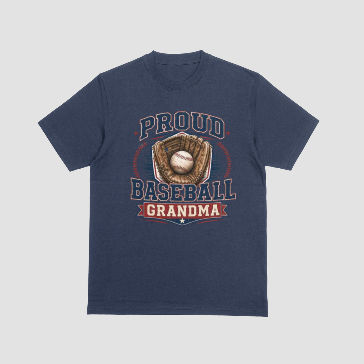 A navy blue short-sleeve crewneck t-shirt with a vintage-style baseball graphic on the front. The graphic features the text 'PROUD BASEBALL GRANDMA' in navy blue and red, surrounding an illustration of a baseball in a brown glove.