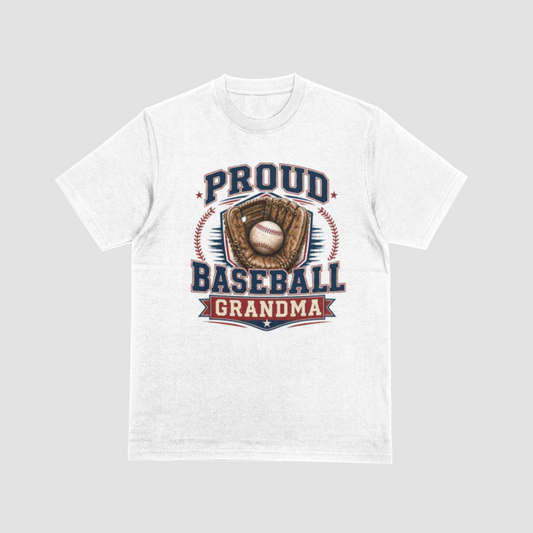 A white short-sleeve crewneck t-shirt with a vintage-style baseball graphic on the front. The graphic features the text 'PROUD BASEBALL GRANDMA' in navy blue and red, surrounding an illustration of a baseball in a brown glove.