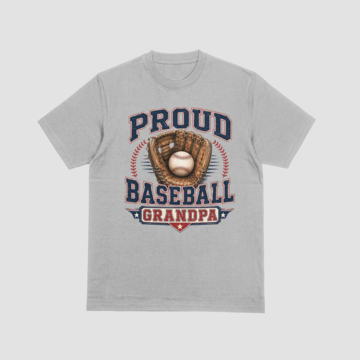 A light grey short-sleeve crewneck t-shirt featuring a vintage-style baseball graphic on the front. The graphic displays the text 'PROUD BASEBALL GRANDPA' in navy blue and red, surrounding an illustration of a baseball in a brown glove.