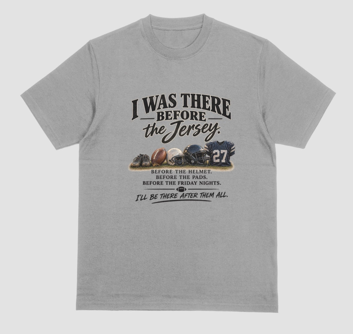 A grey short-sleeve t-shirt with a vintage-style football graphic on the chest. The graphic features footballs and a helmet and a jersey with the number 27, accompanied by the text 'I WAS THERE BEFORE the Jersey.