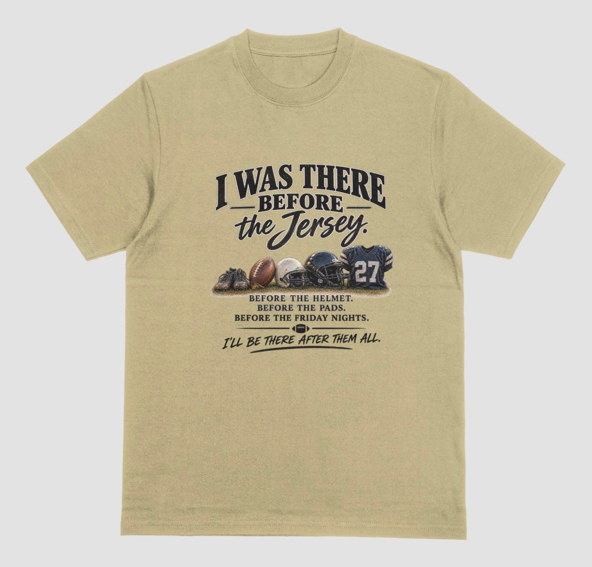 A sand color short-sleeve t-shirt with a vintage-style football graphic on the chest. The graphic features footballs and a helmet and a jersey with the number 27, accompanied by the text 'I WAS THERE BEFORE the Jersey.