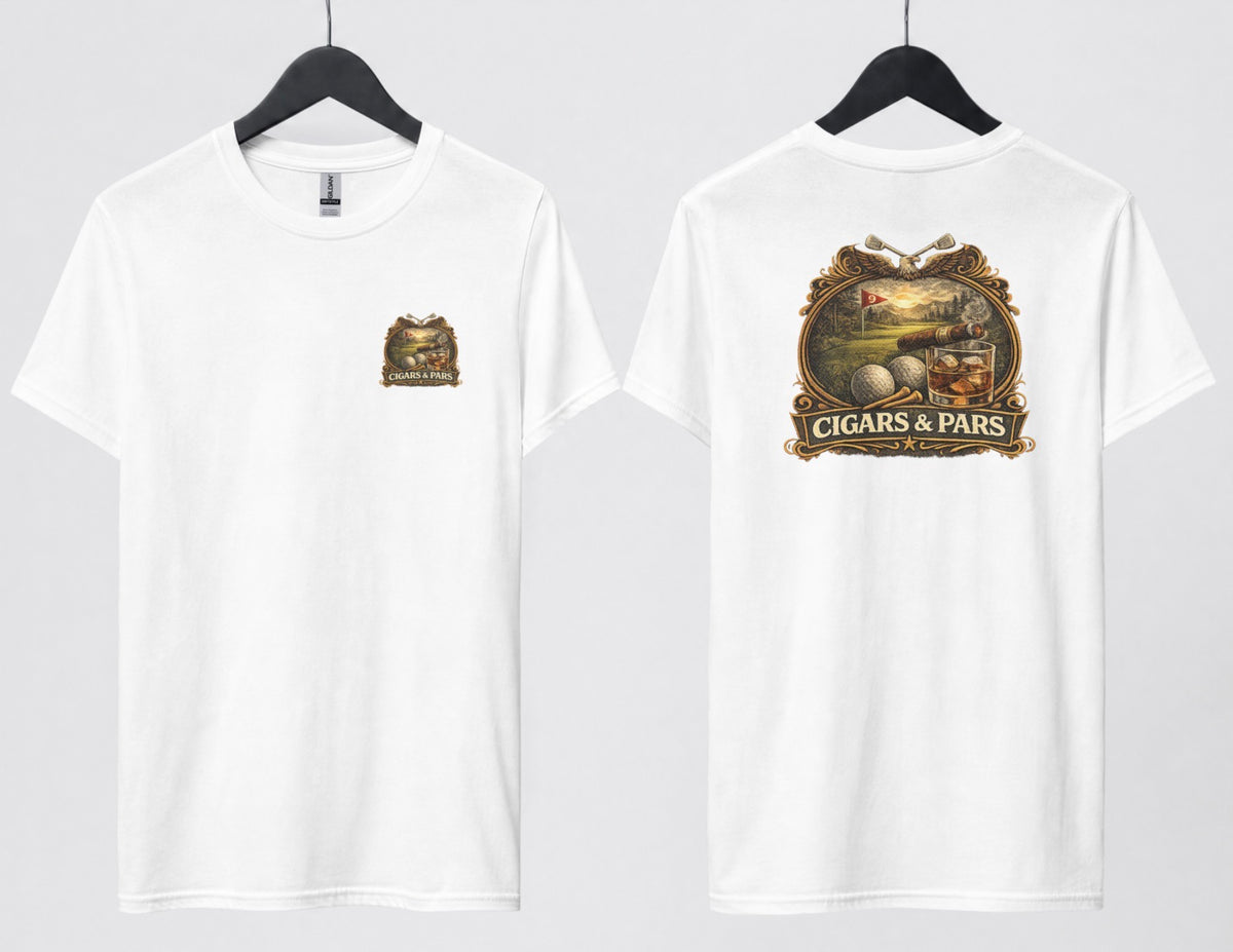A white t-shirt, front and back views on hangers. Front features a small crest-style graphic on the left chest with a golf course scene, crossed clubs, golf balls, and a cigar, framed above a banner reading 'Cigars & Pars.' Back features the same design enlarged: an eagle with crossed golf clubs above an oval scene of a golf green with a flag reading '9,' bordered below by golf balls, tees, a cigar, and a whiskey glass with ice, all above a decorative banner reading 'Cigars & Pars' with a star."