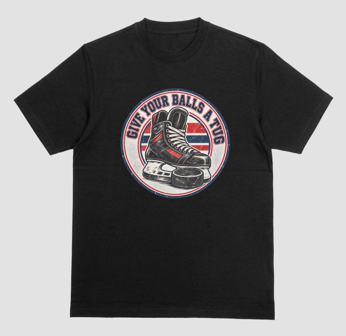 Black t-shirt with a round vintage crest reading 'Give Your Balls a Tug' around a hockey skate and puck in red, white, and blue.