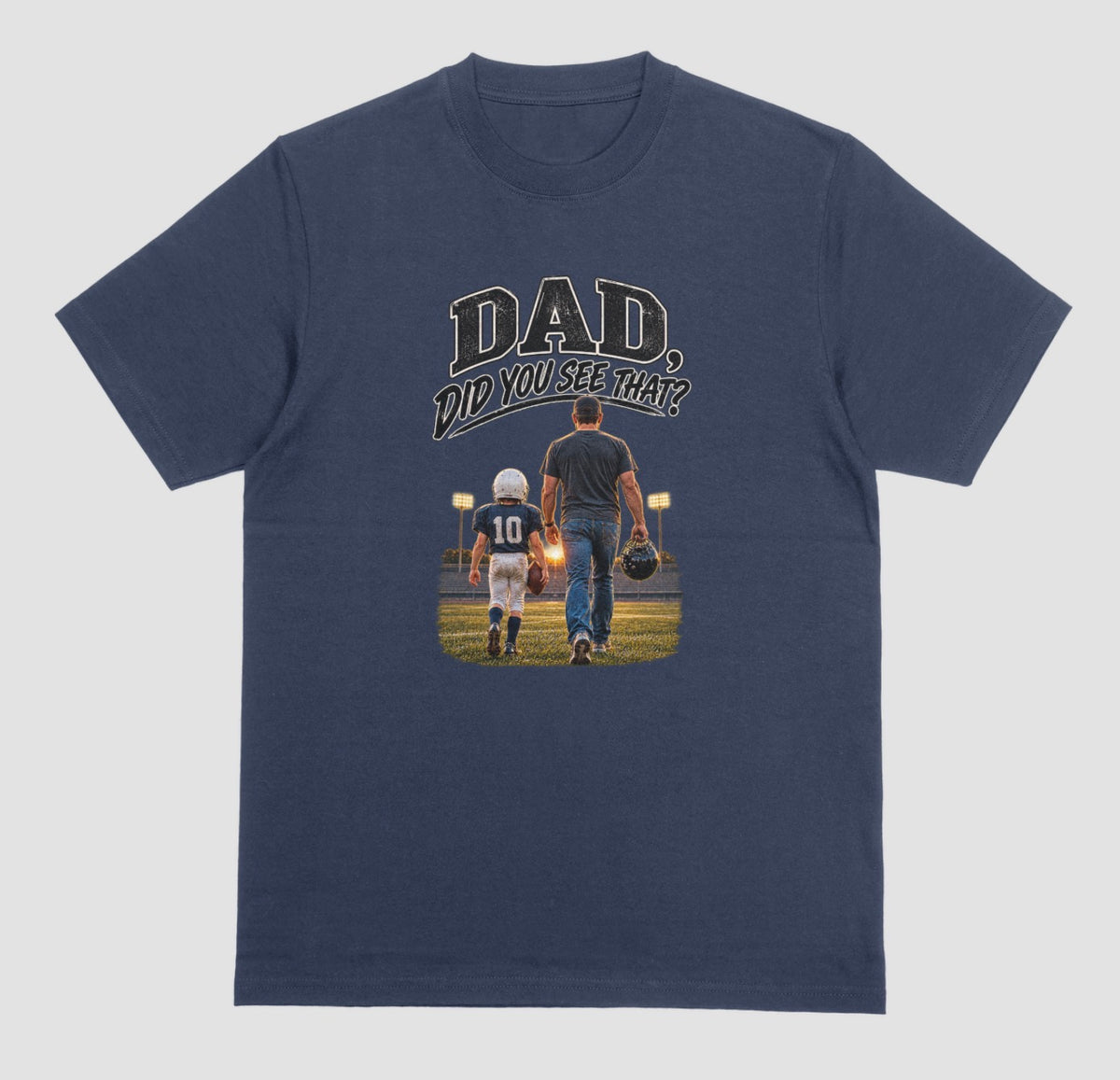 A navy blue crewneck t-shirt featuring a graphic print on the front. The graphic shows a father and son walking on a football field at night, with the text 'DAD DID YOU SEE THAT?' above them.