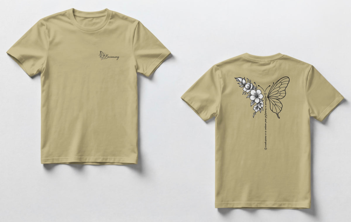 A sand color t-shirts shown side by side. The front has a small script logo on the chest, and the back has a black line-art butterfly with flowers and a vertical line of small text.”