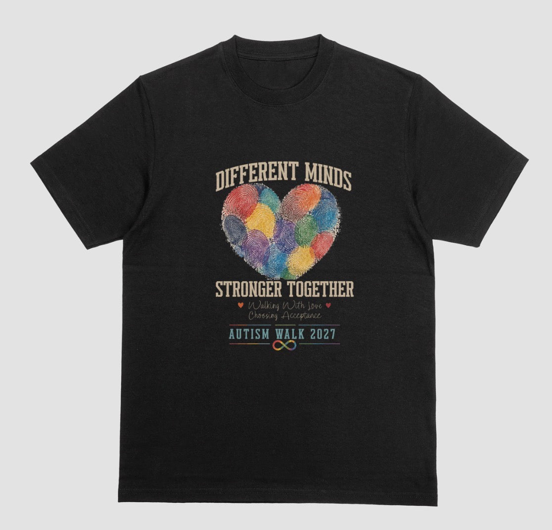 A black crewneck t-shirt featuring a graphic design for the 'Autism Walk 2027'. The design includes the text 'DIFFERENT MINDS STRONGER TOGETHER' in blue, a heart made of colorful fingerprint patterns in the center, and the 'Autism Walk 2027' logo at the bottom.