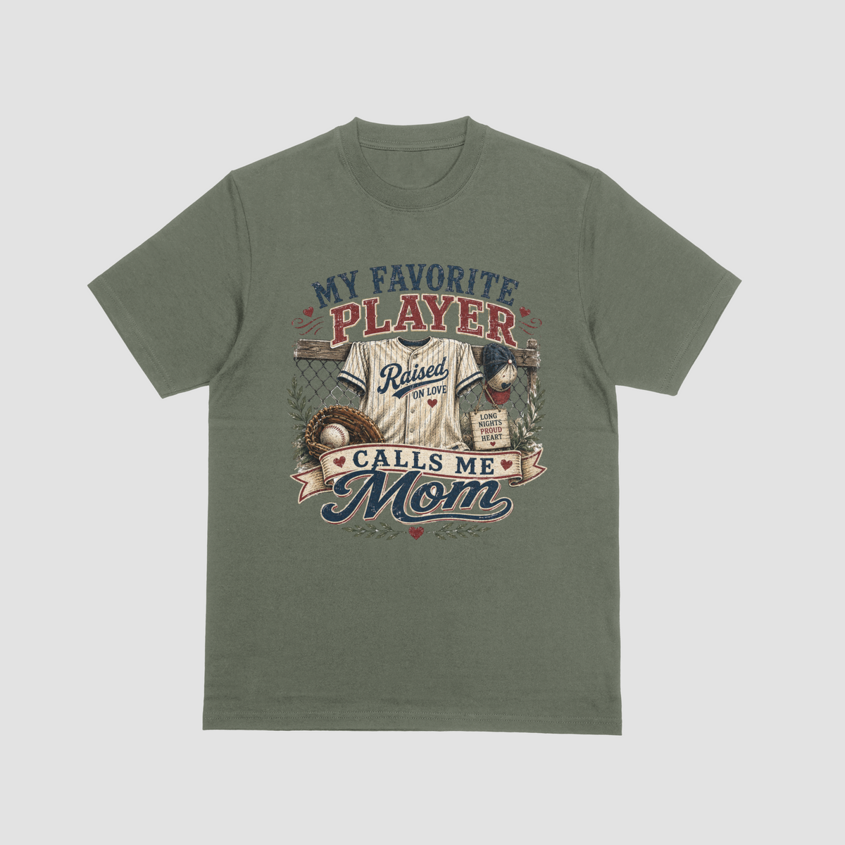 A military green crewneck t-shirt featuring a baseball-themed graphic with a jersey, glove, and baseball, and the text “MY FAVORITE PLAYER CALLS ME MOM.”