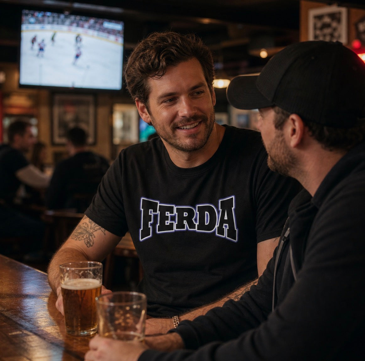 Two friends at the bar one wearing a black FERDA crewneck t-shirt