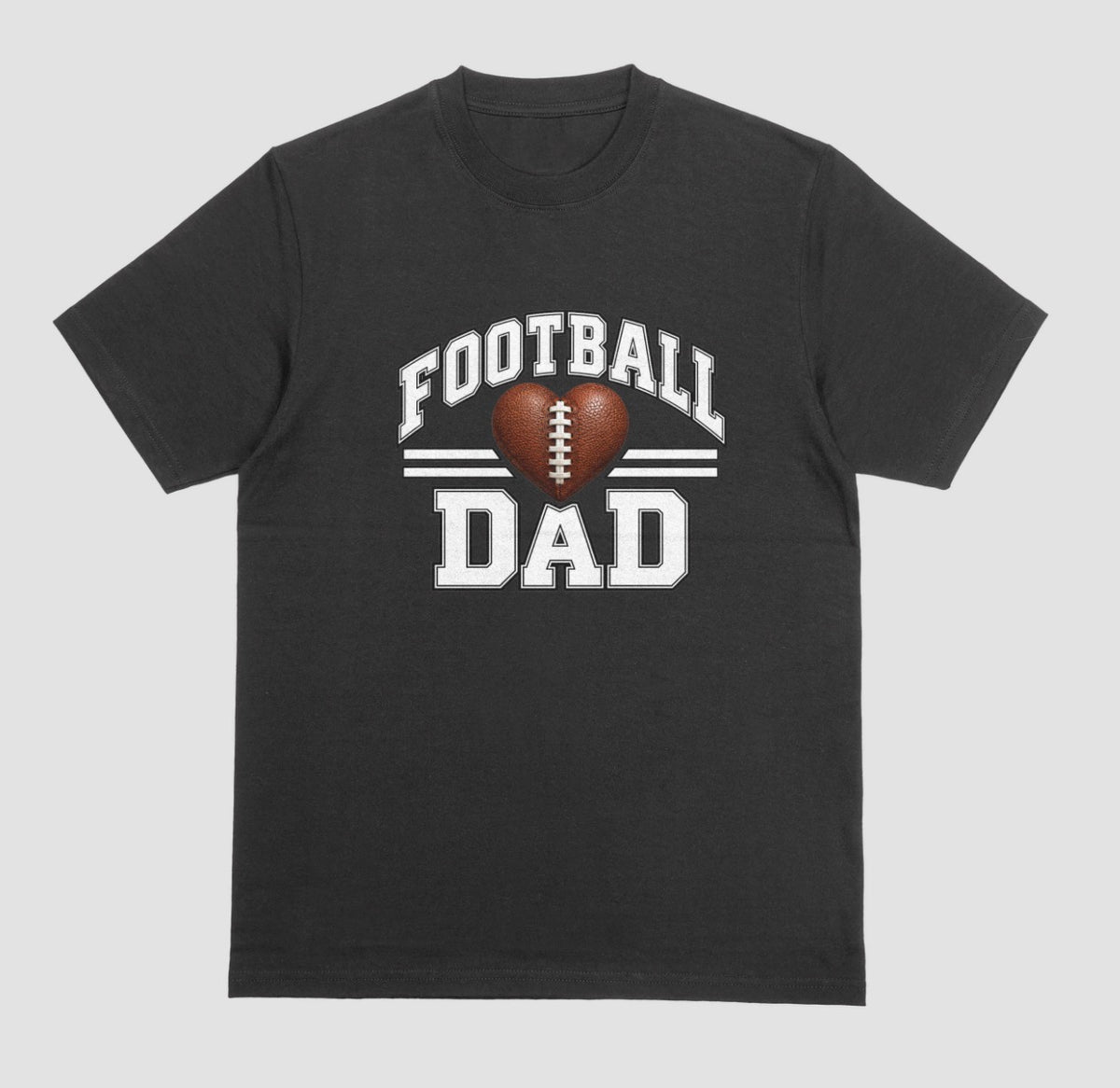 A black short-sleeve t-shirt with a 'FOOTBALL DAD' graphic on the chest. The graphic features a brown heart-shaped football in the center, flanked by two white horizontal stripes, with 'FOOTBALL' arched above and 'DAD' printed below in a distressed white font.