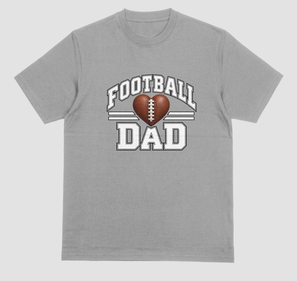 A grey short-sleeve t-shirt with a 'FOOTBALL DAD' graphic on the chest. The graphic features a brown heart-shaped football in the center, flanked by two white horizontal stripes, with 'FOOTBALL' arched above and 'DAD' printed below in a distressed white font.