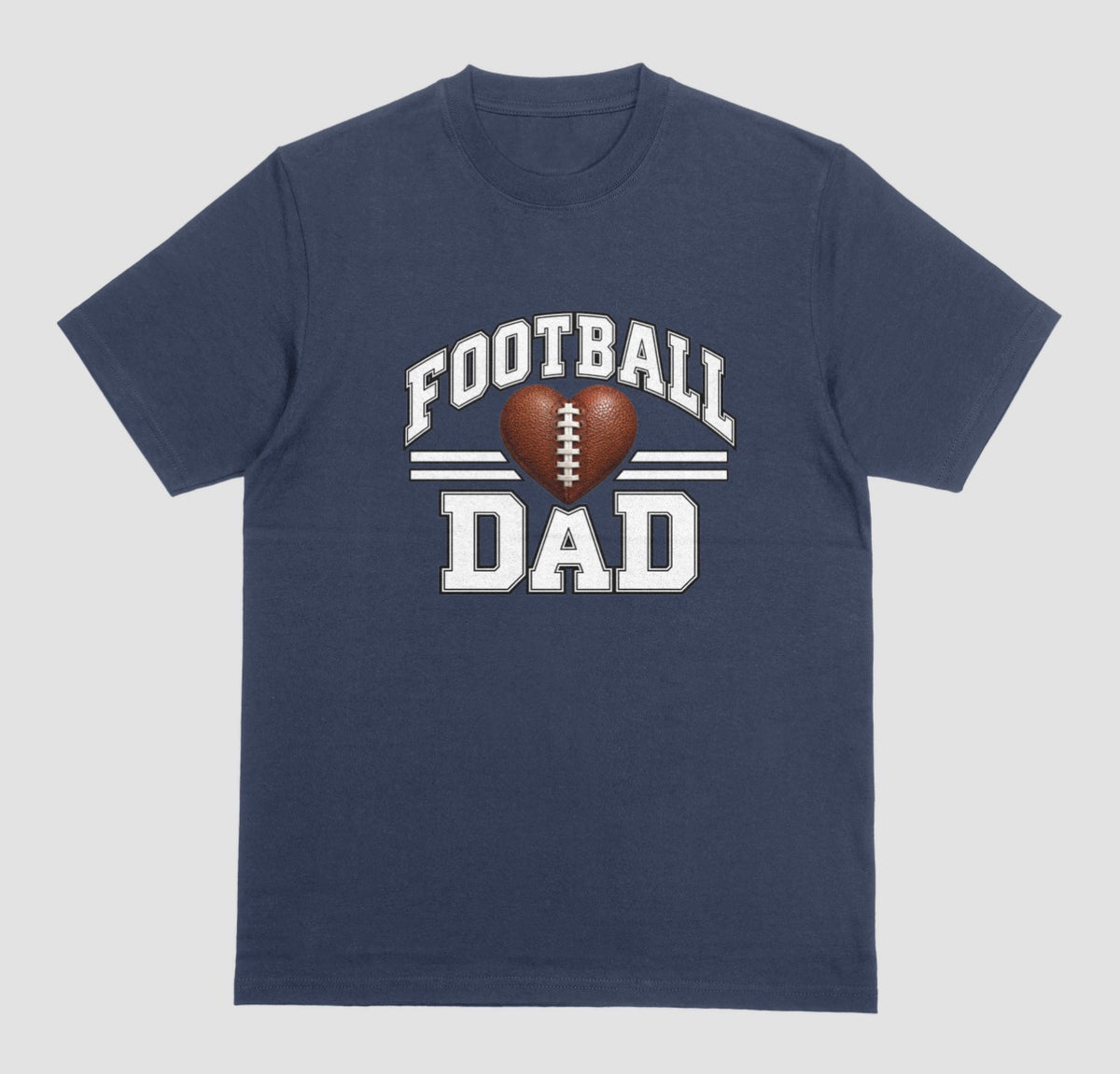 A navy blue short-sleeve t-shirt with a 'FOOTBALL DAD' graphic on the chest. The graphic features a brown heart-shaped football in the center, flanked by two white horizontal stripes, with 'FOOTBALL' arched above and 'DAD' printed below in a distressed white font.