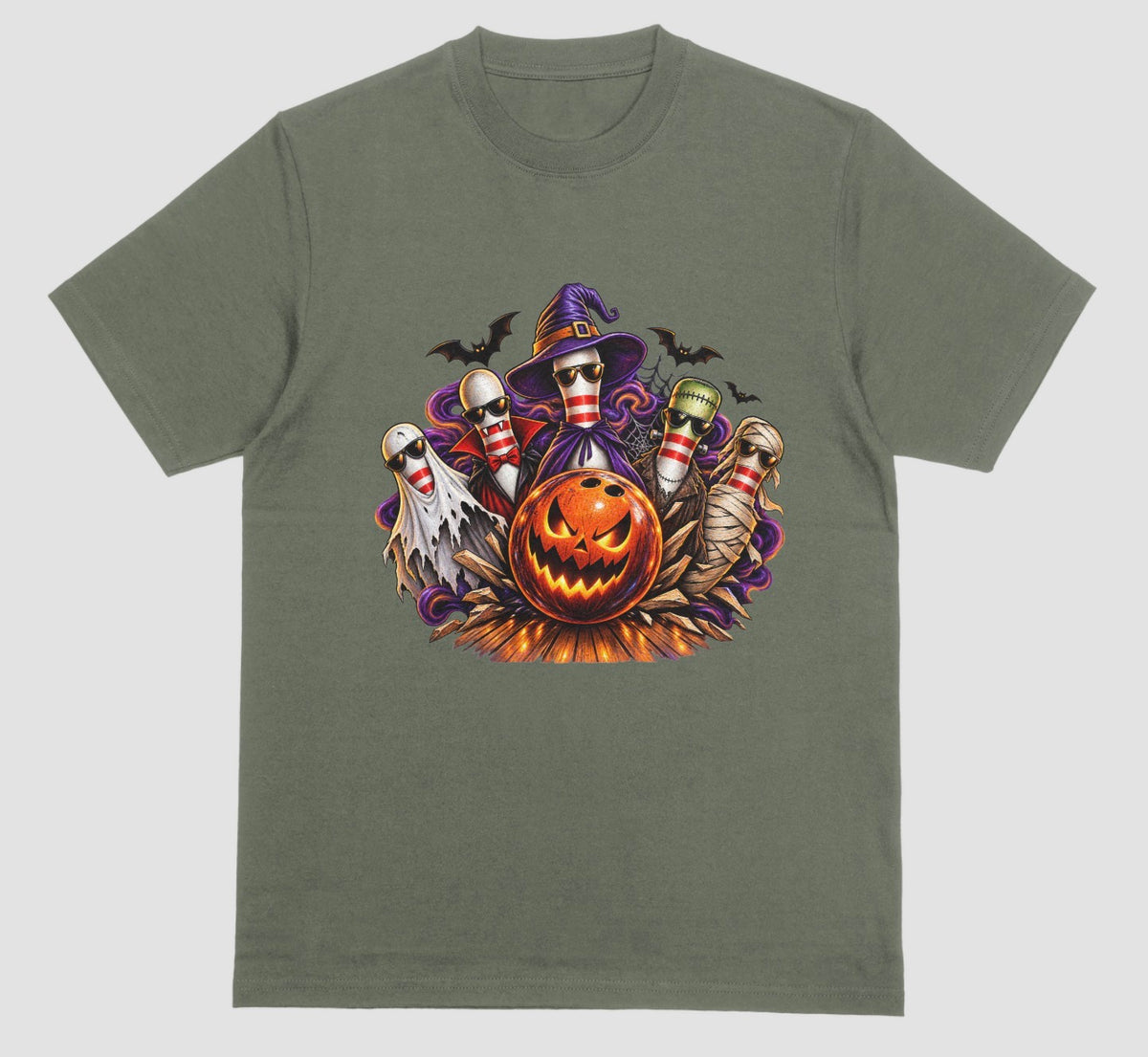 A military green Halloween bowling t-shirt featuring a graphic of five bowling pins dressed as a ghost, vampire, witch, Frankenstein's monster, and mummy, all wearing sunglasses, behind a glowing jack-o'-lantern bowling ball