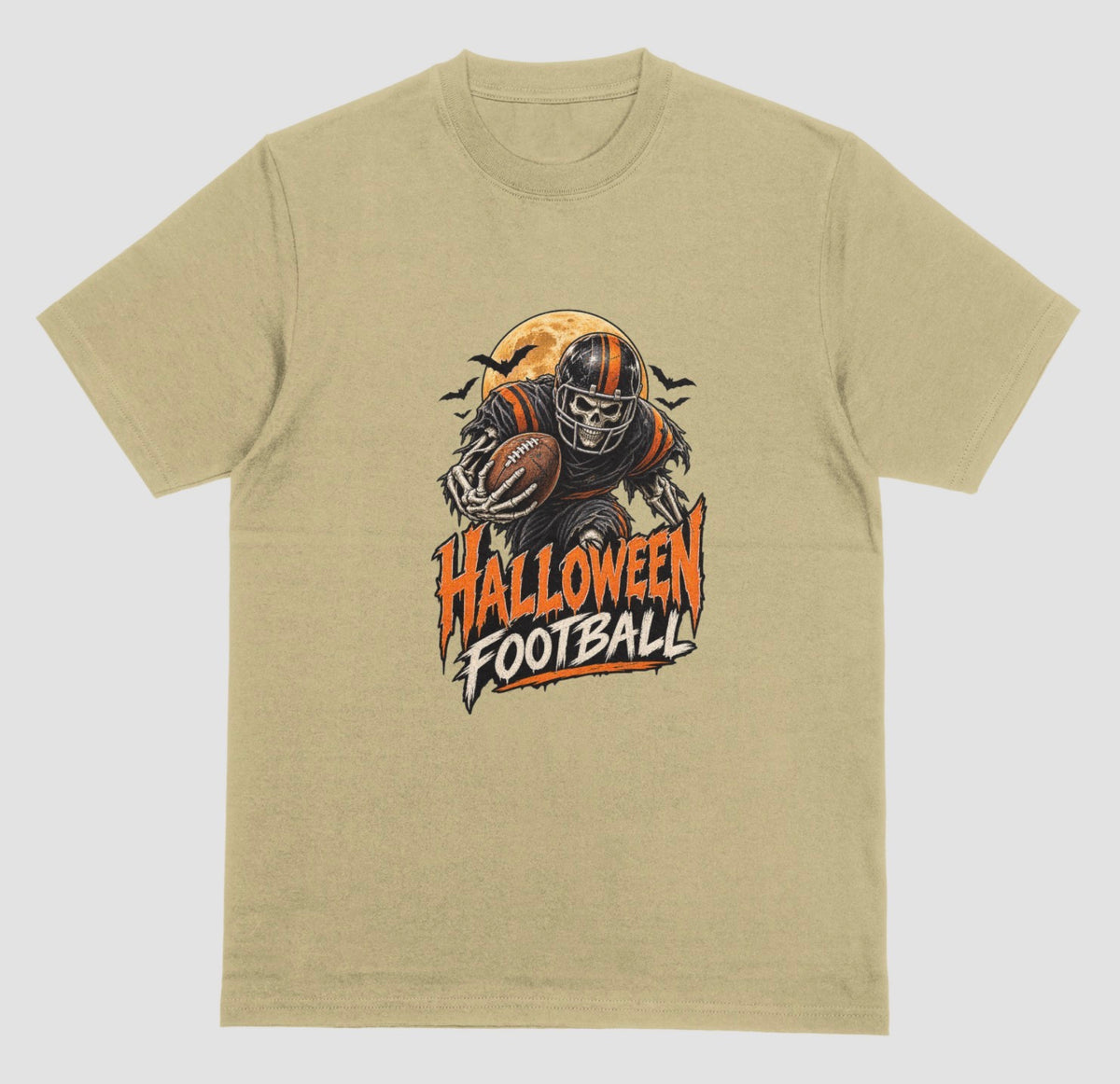 A sand color t-shirt reading "Halloween Football" in orange and cream lettering, with a skeleton football player in a striped helmet carrying a football in front of a full moon and bats
