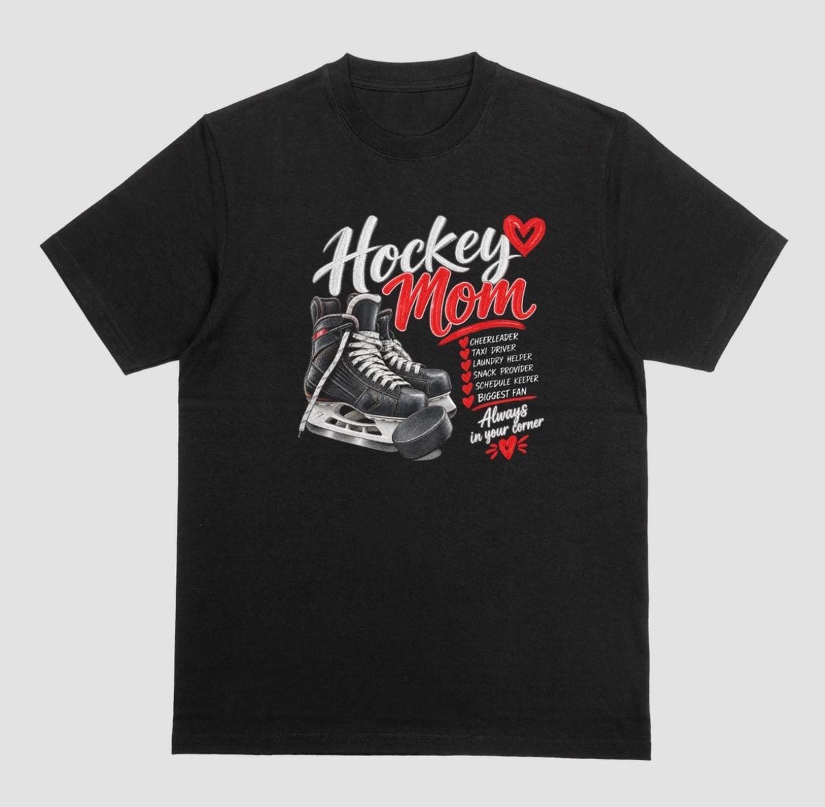 A black "Hockey Mom" t-shirt with black hockey skates, puck, and red heart design listing cheerleader, taxi driver, and biggest fan, with the tagline "Always in their corner"