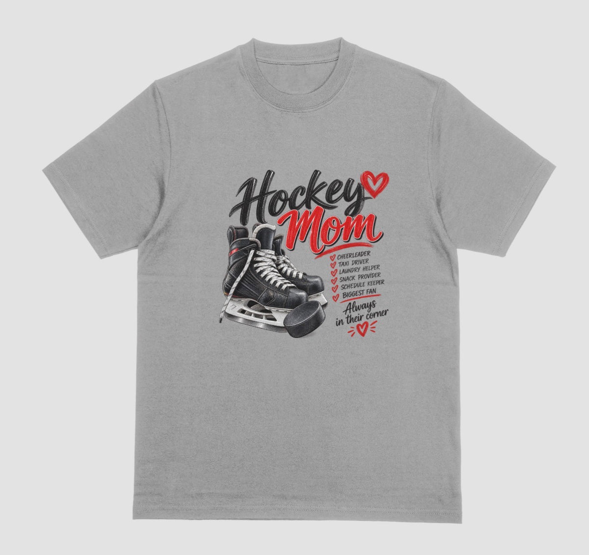 A Grey "Hockey Mom" t-shirt with black hockey skates, puck, and red heart design listing cheerleader, taxi driver, and biggest fan, with the tagline "Always in their corner"