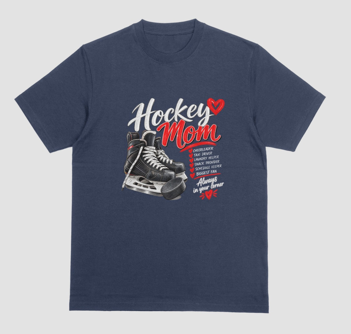 A navy blue "Hockey Mom" t-shirt with black hockey skates, puck, and red heart design listing cheerleader, taxi driver, and biggest fan, with the tagline "Always in their corner"