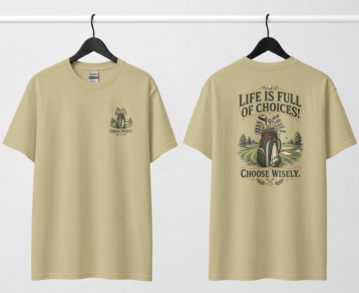 A sand color short-sleeve t-shirt shown from both the front and back, hanging on black hangers against a white wall. The design features a vintage-style illustration of a golf bag filled with clubs on a golf course, framed by the text 'LIFE IS FULL OF CHOICES! CHOOSE Wisely.