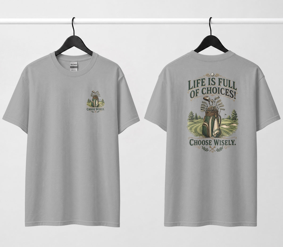 A heather grey short-sleeve t-shirt shown from both the front and back, hanging on black hangers against a white wall. The design features a vintage-style illustration of a golf bag filled with clubs on a golf course, framed by the text 'LIFE IS FULL OF CHOICES! CHOOSE Wisely.