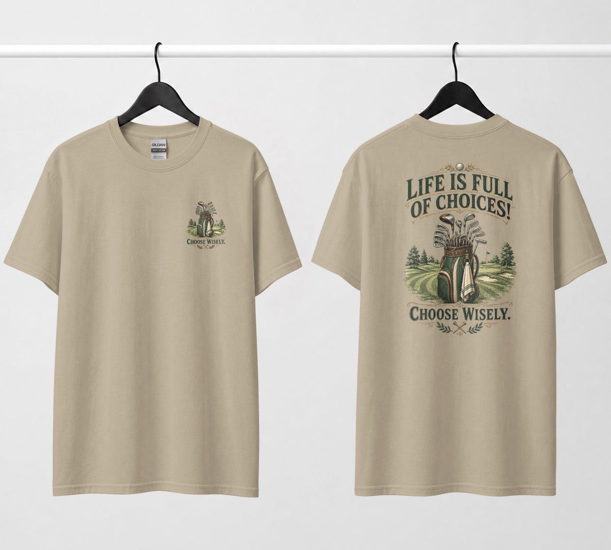 A prairie dust color short-sleeve t-shirt shown from both the front and back, hanging on black hangers against a white wall. The design features a vintage-style illustration of a golf bag filled with clubs on a golf course, framed by the text 'LIFE IS FULL OF CHOICES! CHOOSE Wisely.