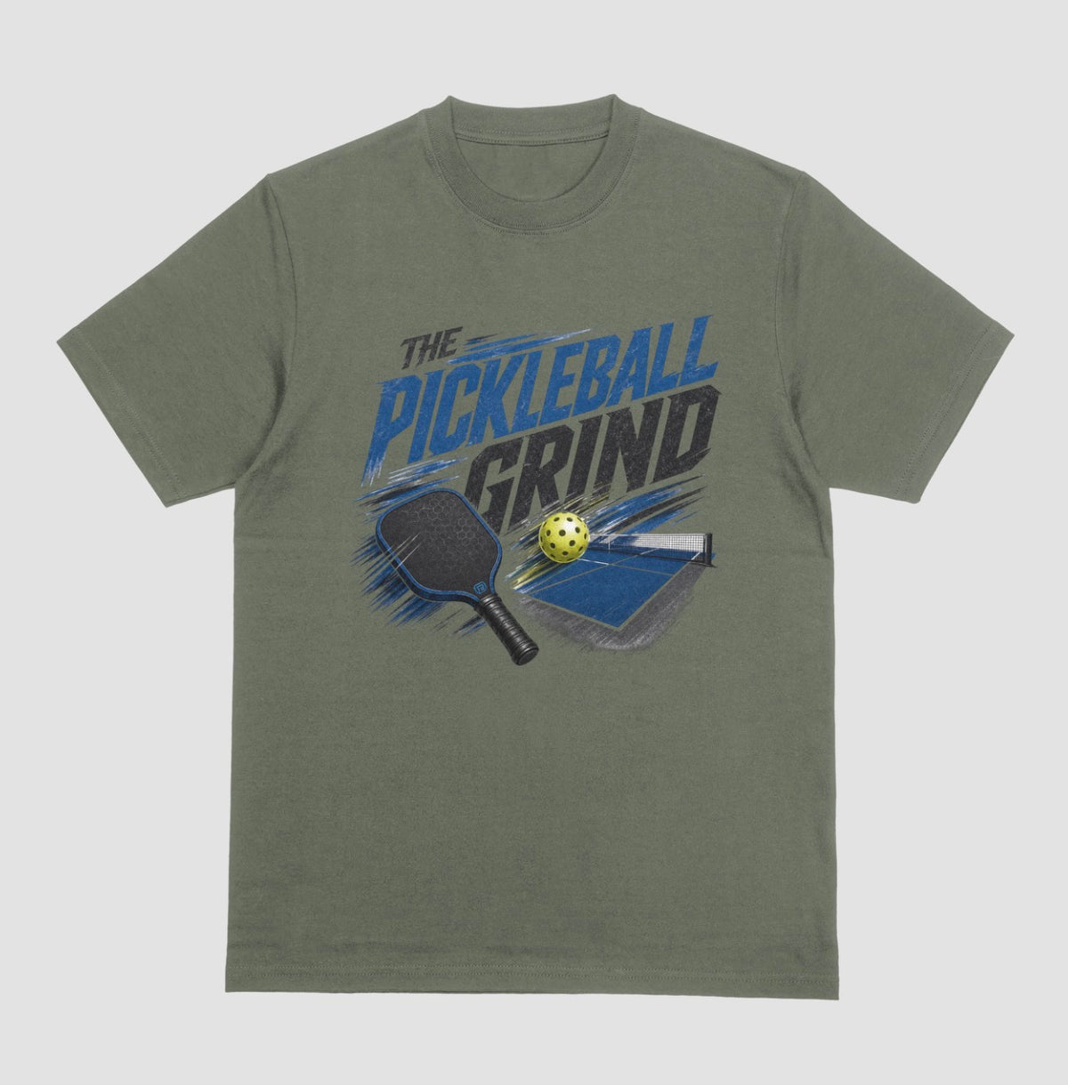 An military green short-sleeve t-shirt with a graphic on the front that reads 'THE PICKLEBALL GRIND' in blue and black, accompanied by illustrations of a pickleball paddle, ball, and table.