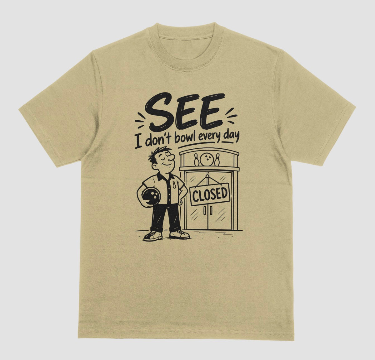 A sand color short-sleeve t-shirt with a graphic print on the front. The graphic features a cartoon bowling player holding a bowling ball next to a bowling alley door with a 'CLOSED' sign, with the text 'SEE I don't bowl every day' above.
