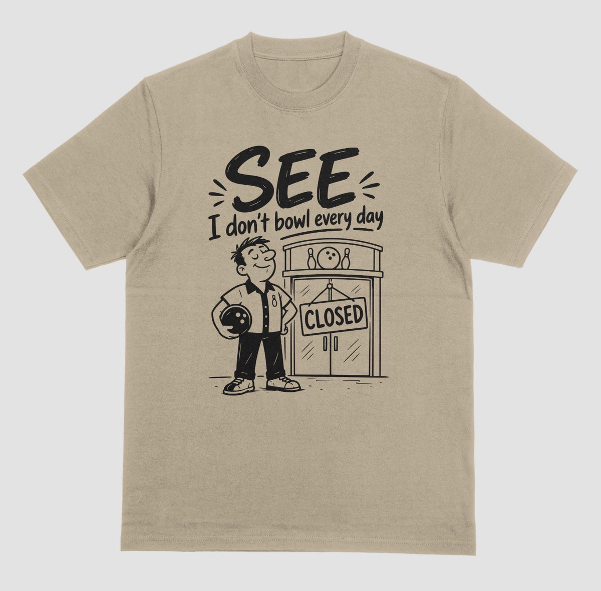 A prairie dust short-sleeve t-shirt with a graphic print on the front. The graphic features a cartoon bowling player holding a bowling ball next to a bowling alley door with a 'CLOSED' sign, with the text 'SEE I don't bowl every day' above.