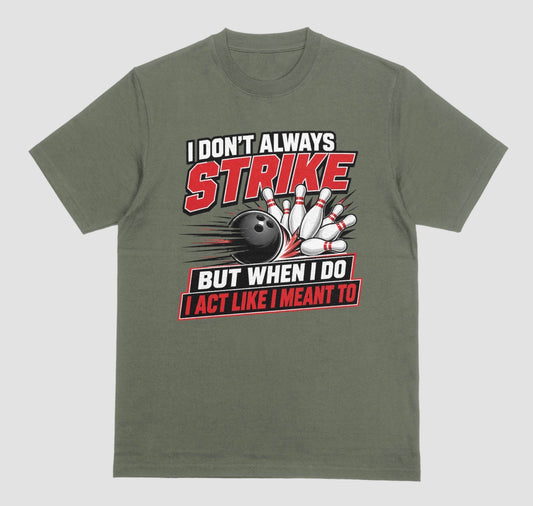 An military green short-sleeve t-shirt with a bowling-themed graphic on the front. The graphic features the text 'I DON'T ALWAYS STRIKE BUT WHEN I DO I ACT LIKE I MEANT TO' in white and red lettering, surrounding an illustration of a black bowling ball and white bowling pins. | Where We Play Apparel