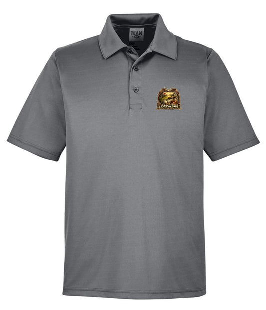 A graphite performance polo shirt, front view, with a left chest crest-style graphic featuring a golf course scene with a flag and golf ball, framed by decorative crossed clubs, above a banner reading 'Cigars & Pars.'
