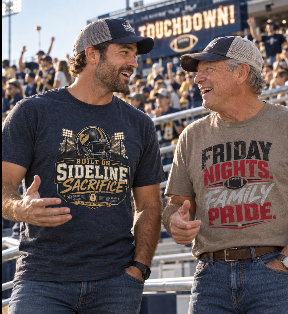 Two men laughing and talking in a stadium crowd, wearing graphic t-shirts. The man on the left wears a navy blue 'Built on Sideline Sacrifice' shirt, and the man on the right wears a taupe 'Friday Nights Family Pride' shirt.