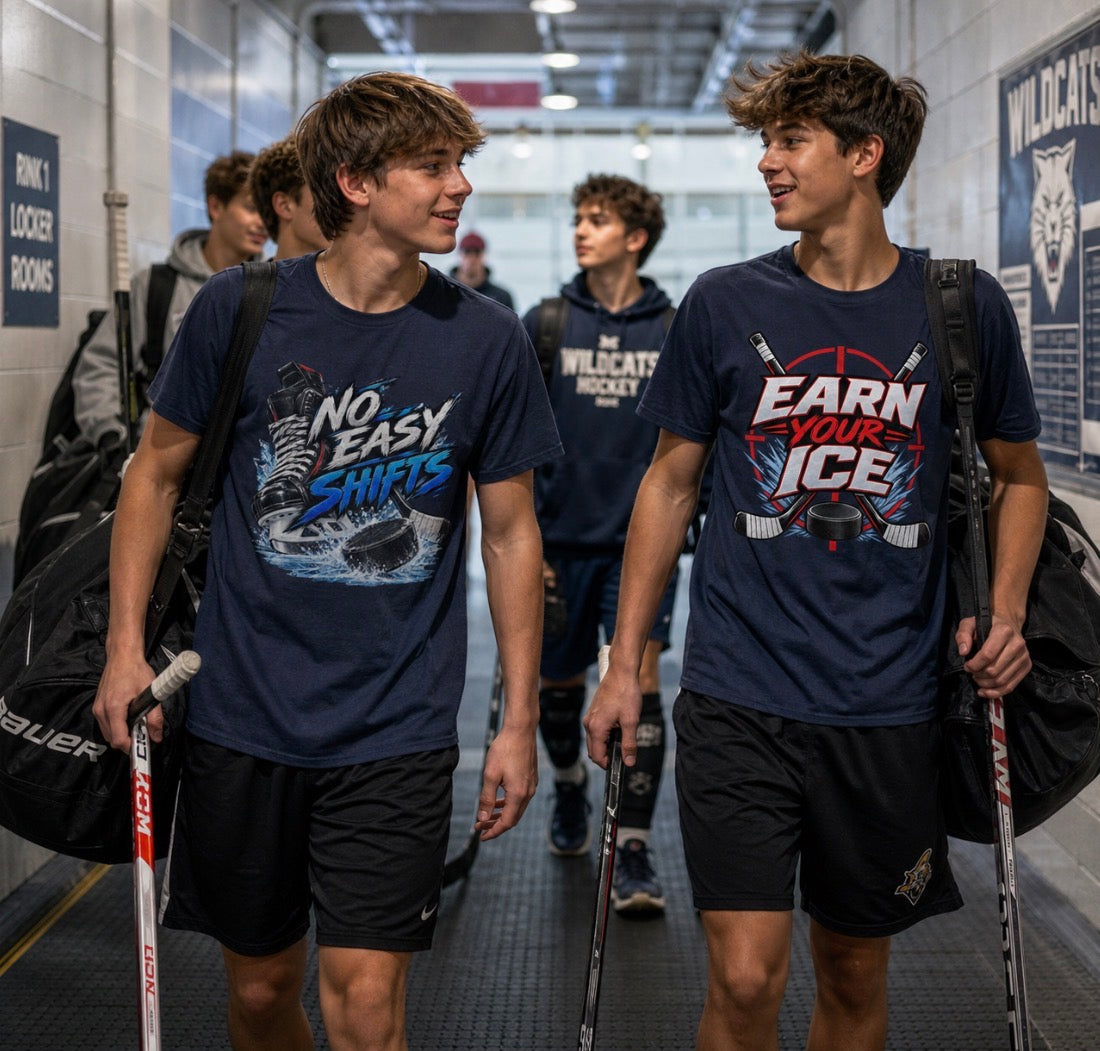 Teen hockey player in a navy "No Easy Shifts" t-shirt carrying a gear bag in a rink hallway, walking with a teammate in an "Earn Your Ice" shirt