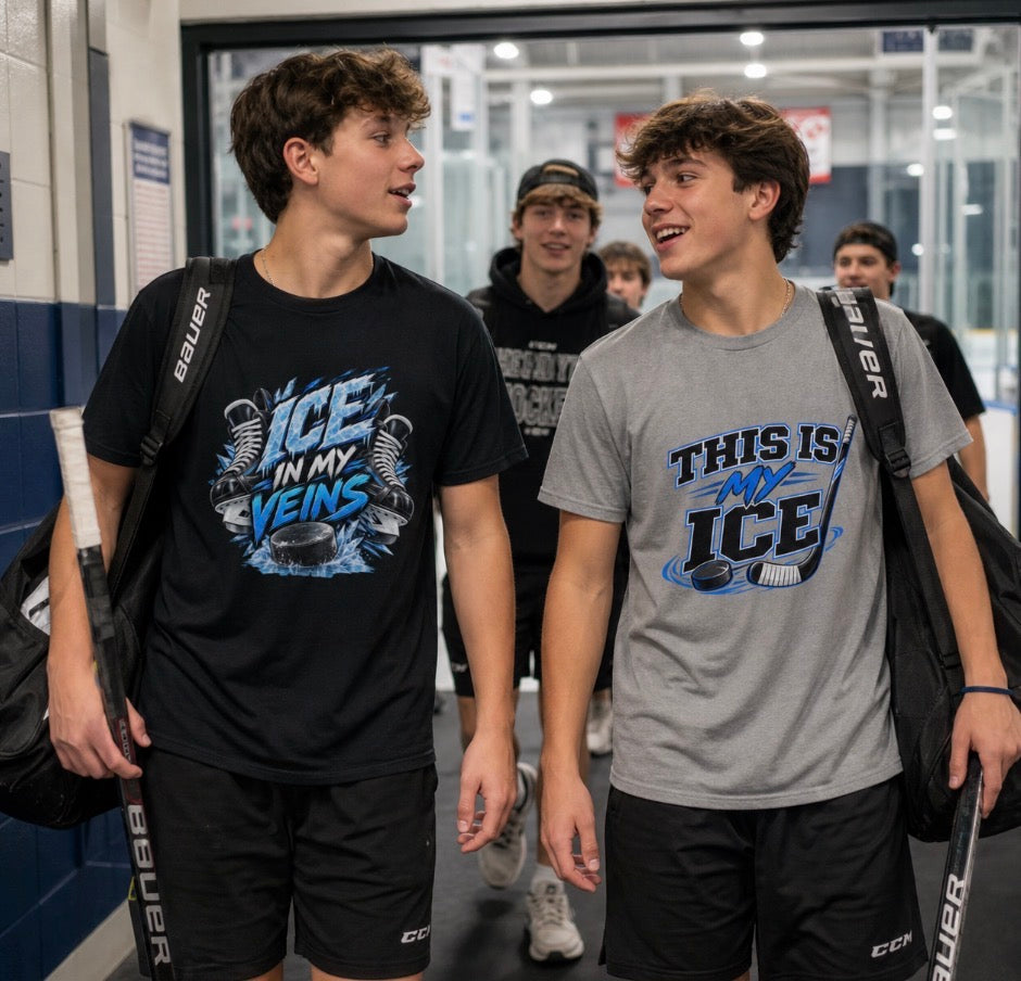Two teen hockey players in a rink hallway wearing "Ice In My Veins" and "This Is My Ice" graphic t-shirts, carrying gear bags and sticks