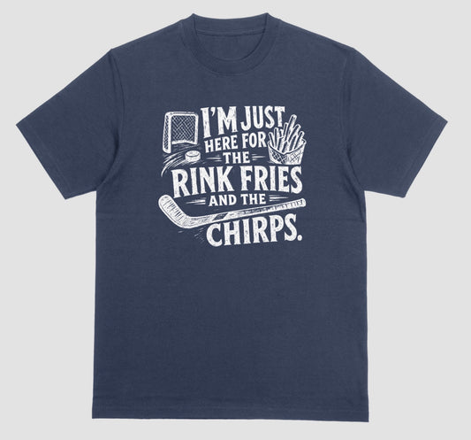 A navy blue t-shirt with white distressed hockey graphic reading “I’m just here for the rink fries and the chirps” with a hockey net, puck, stick, and fries