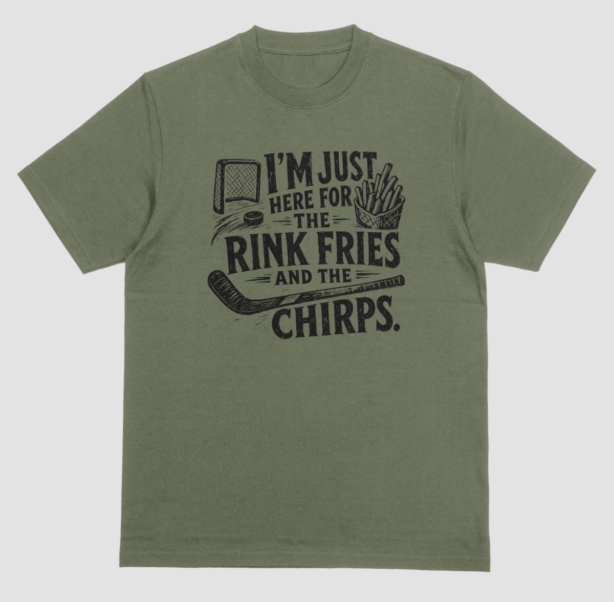 A military green t-shirt with black distressed hockey graphic reading “I’m just here for the rink fries and the chirps” with a hockey net, puck, stick, and fries