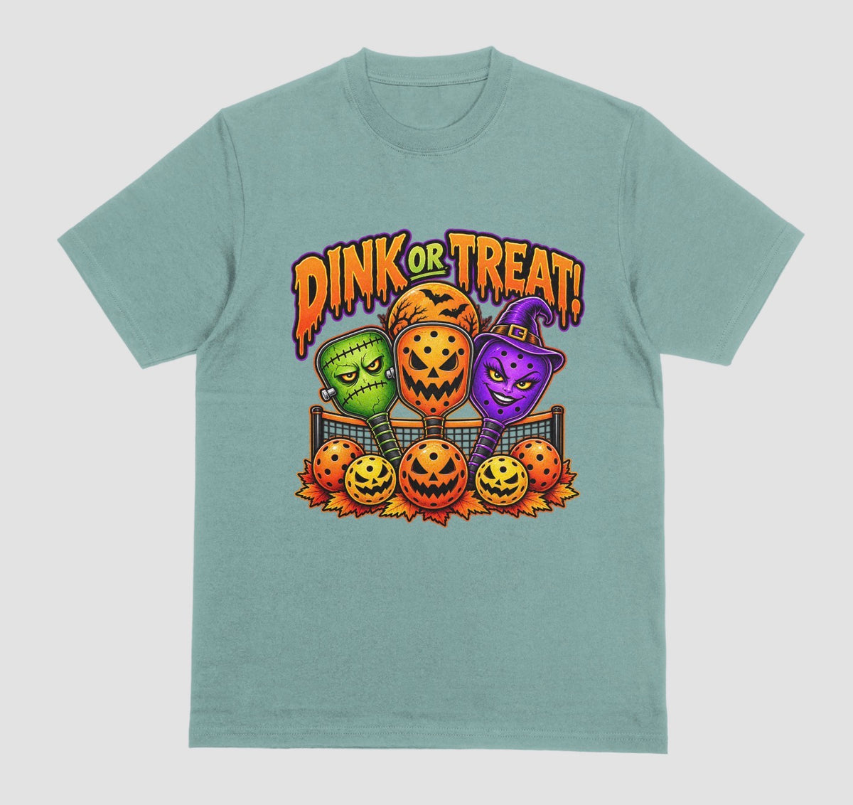 A aquatic green t-shirt with “Dink or Treat!” Halloween design of three spooky pickleball paddles and jack-o’-lantern pickleballs