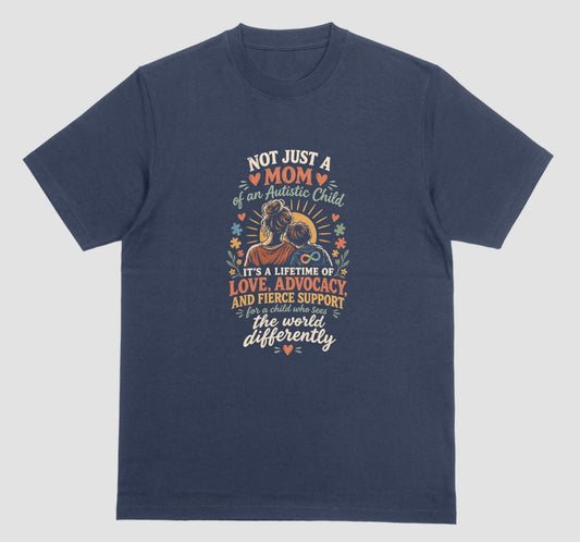 A navy blue t-shirt with a retro-style graphic of a mother holding her child and the text ‘Not Just a Mom of an Autistic Child. It’s a lifetime of love, advocacy, and fierce support for a child who sees the world differently.’