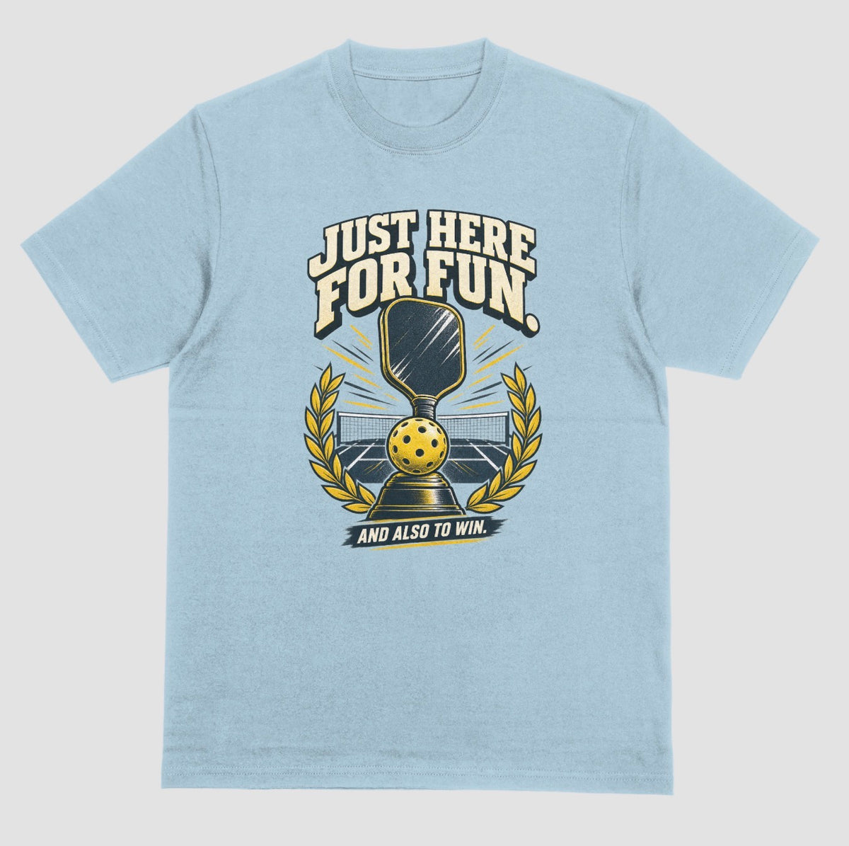 A light blue Funny pickleball shirt with a trophy, paddle and laurel wreath design that says Just Here for Fun and Also to Win