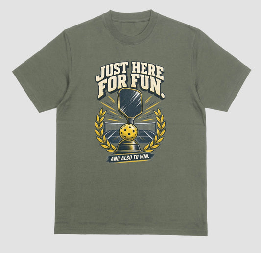 A military green Funny pickleball shirt with a trophy, paddle and laurel wreath design that says Just Here for Fun and Also to Win