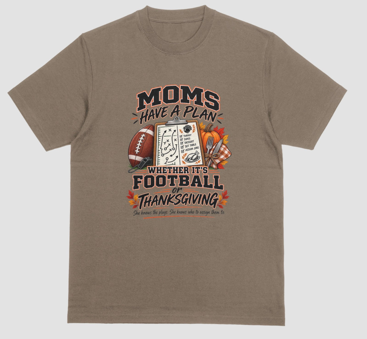 A brown savana t-shirt featuring 'Moms Have a Plan, Whether It's Football or Thanksgiving' quote with football, clipboard playbook, pumpkin, and turkey dinner graphics"
