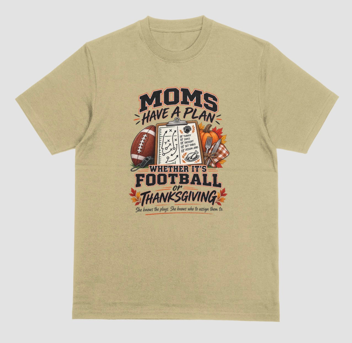 Sand t-shirt featuring 'Moms Have a Plan, Whether It's Football or Thanksgiving' quote with football, clipboard playbook, pumpkin, and turkey dinner graphics"