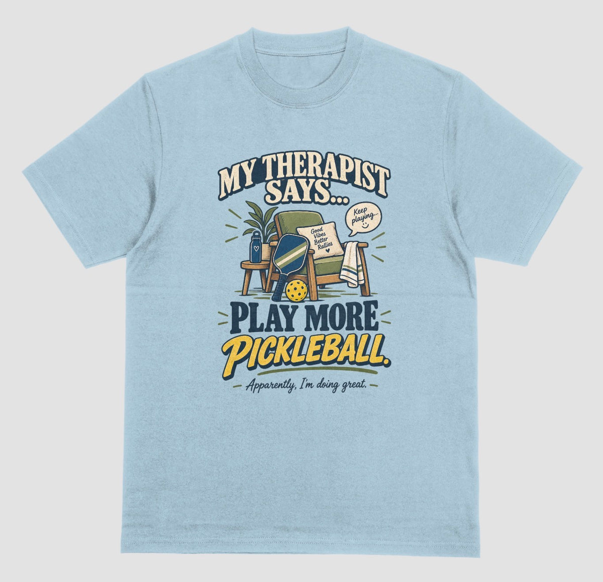 Funny pickleball shirt in light blue with an armchair and paddle design that says My Therapist Says Play More Pickleball