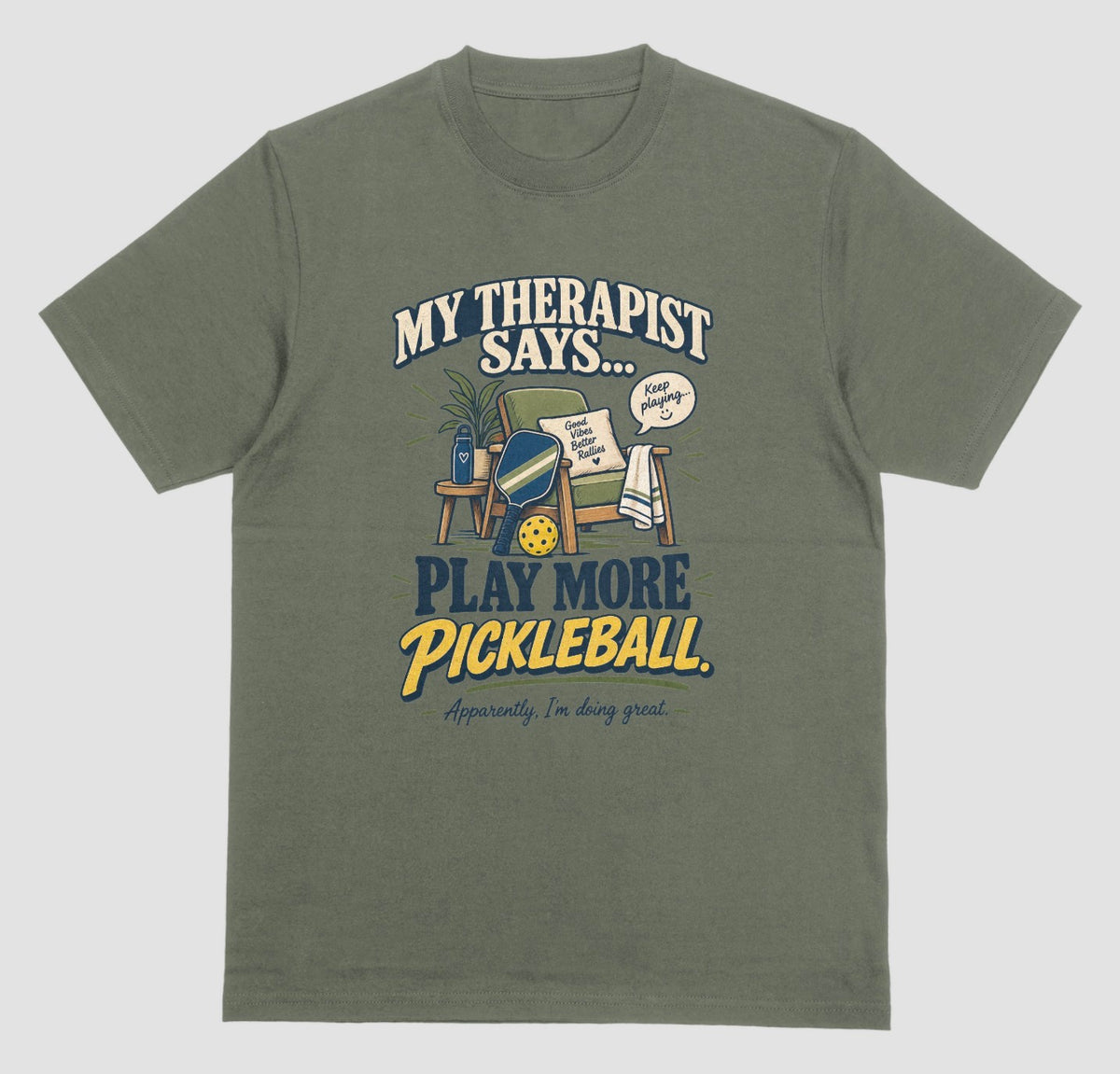 A military green Funny pickleball shirt with an armchair and paddle design that says My Therapist Says Play More Pickleball